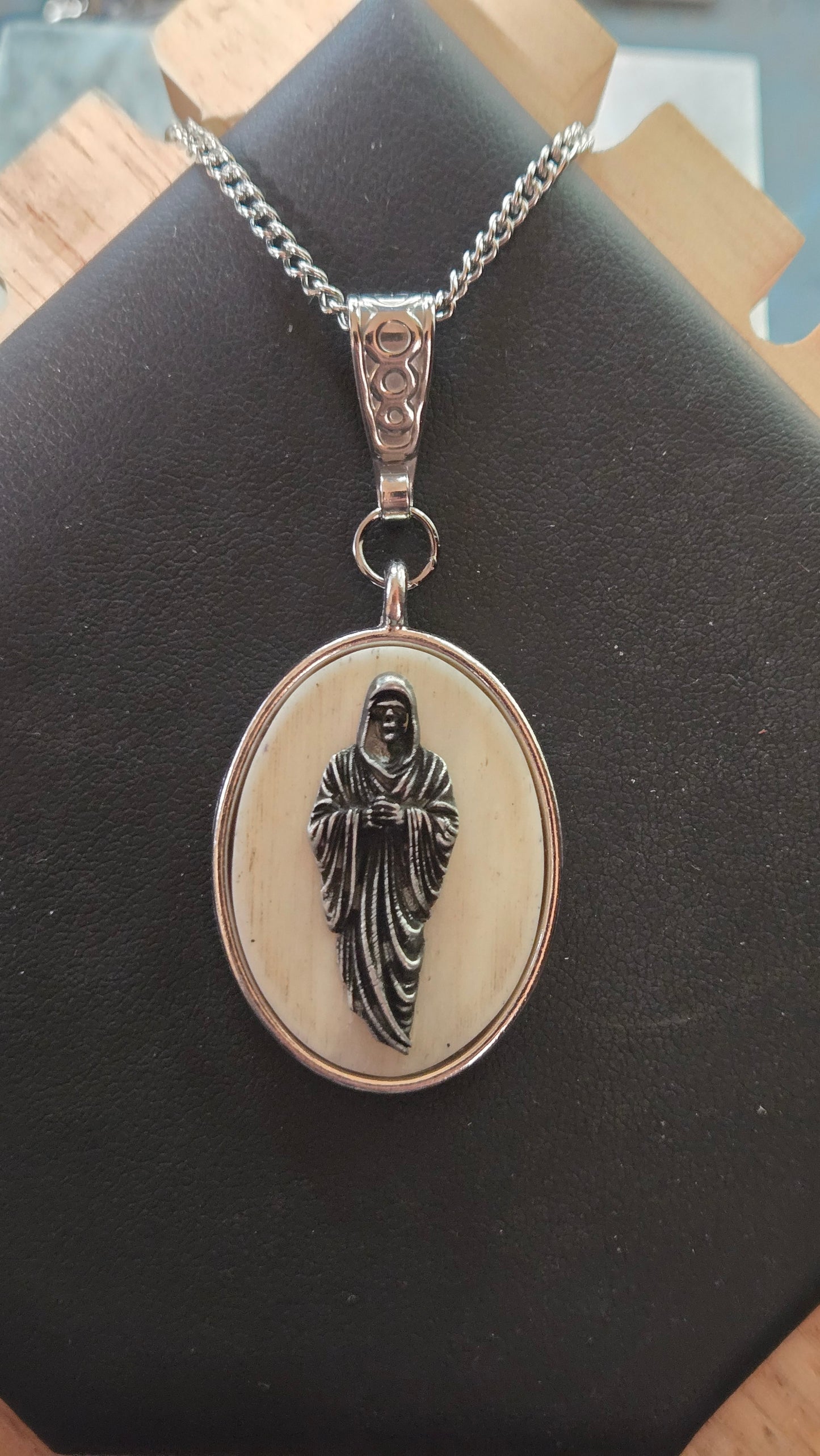 Hand-Shaped Human Bone Pendant with Engraved Reaper