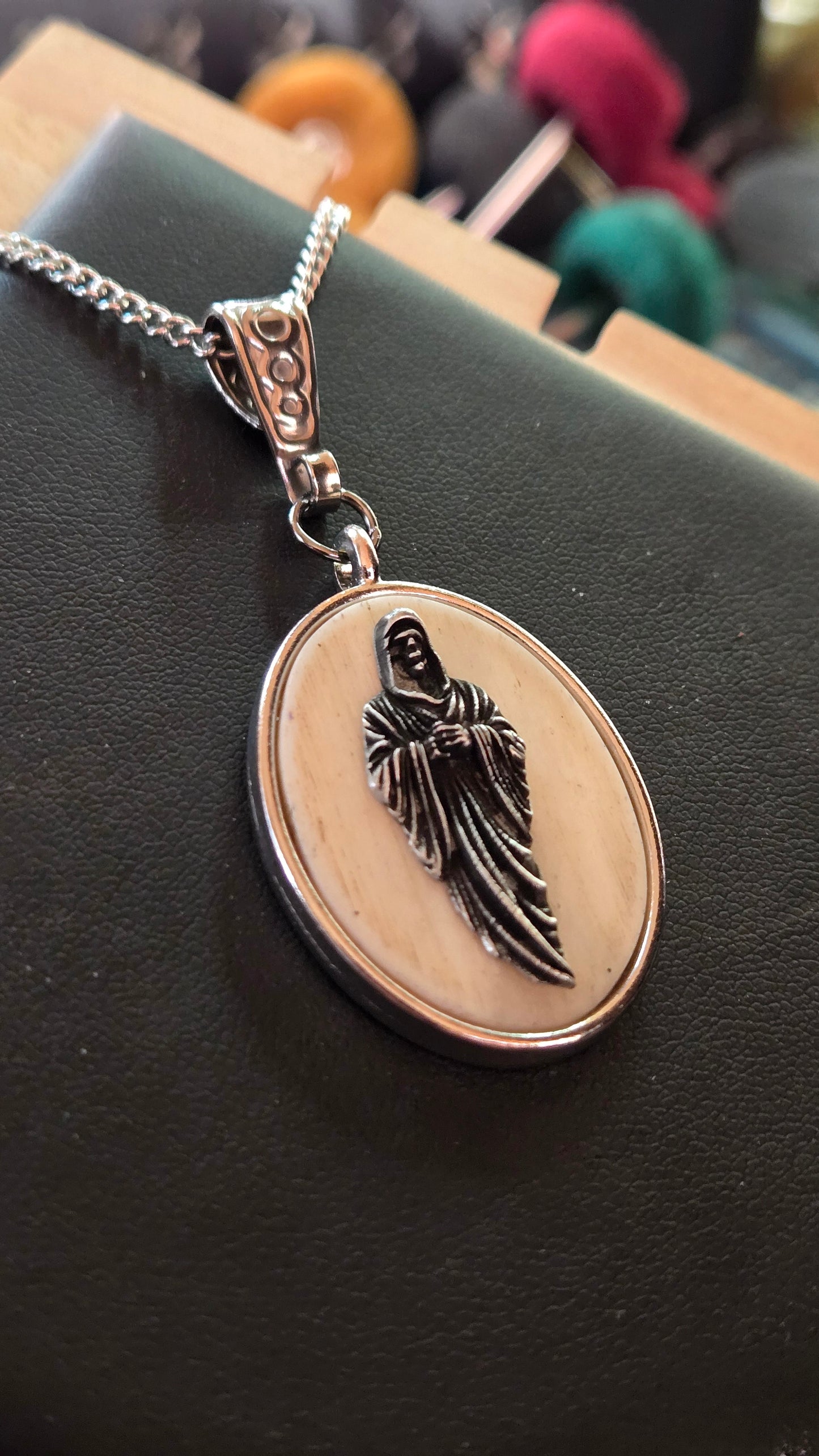 Hand-Shaped Human Bone Pendant with Engraved Reaper