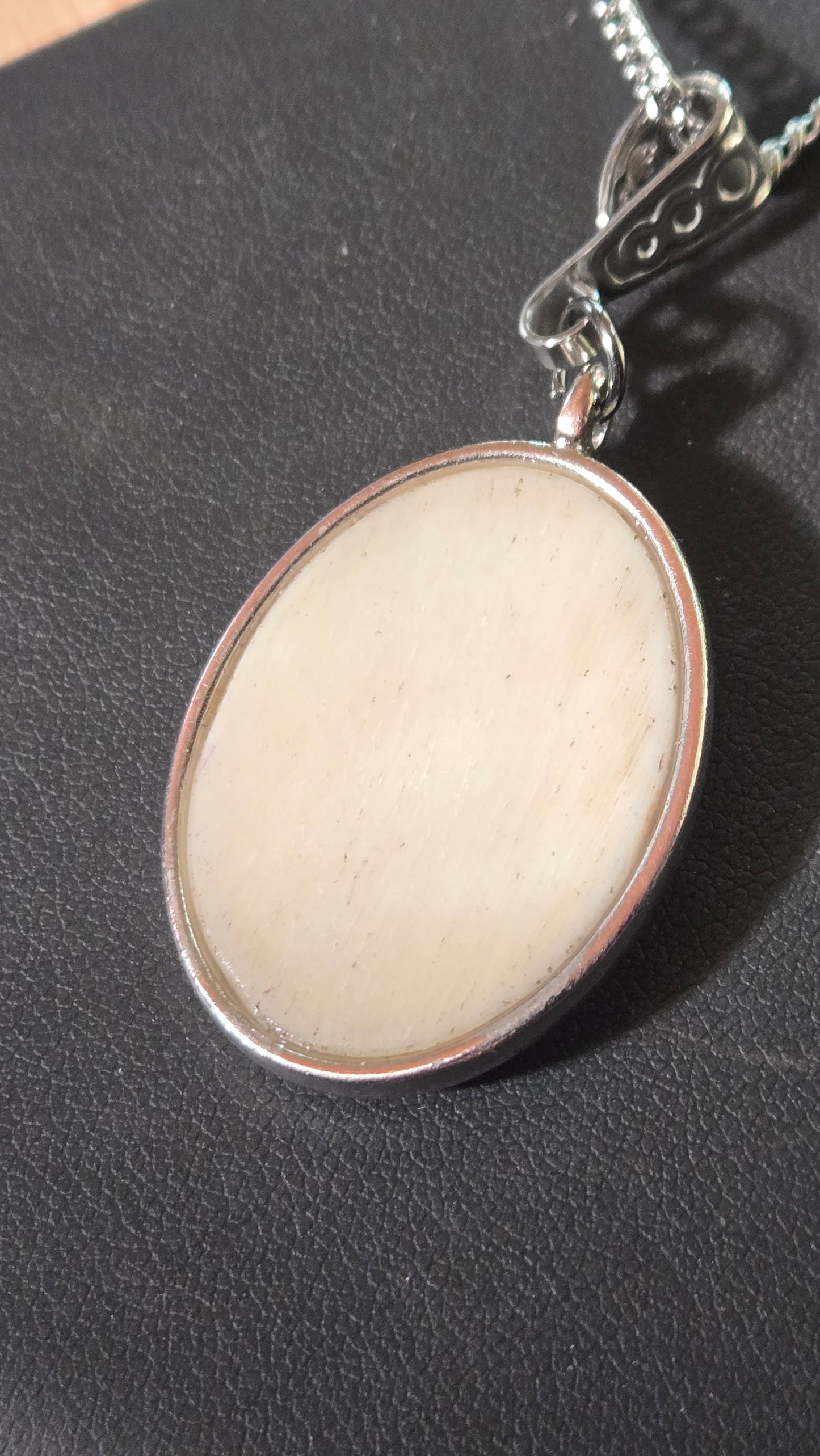 Hand-Shaped Human Bone Pendant with Engraved Reaper