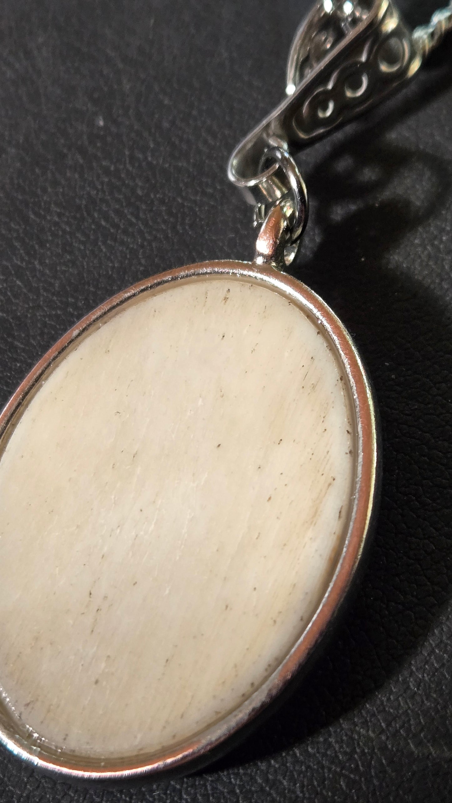 Hand-Shaped Human Bone Pendant with Engraved Reaper